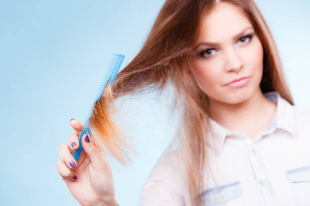 istock Long haired woman combing her hair. 668151548