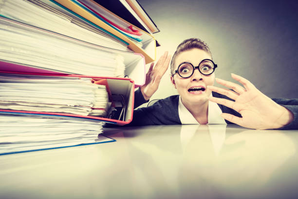 istock Accountant terrified of pils of binders. 668154234