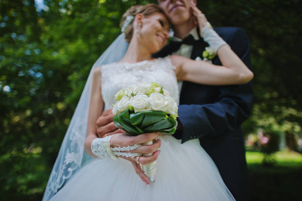 istock exciting elegant wedding couple walking at park in love 668157894