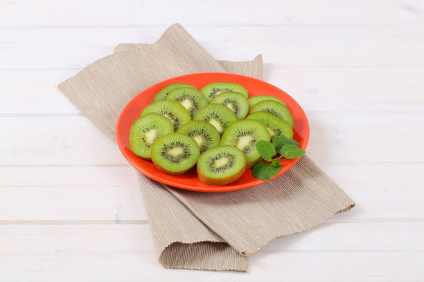 plate of sliced kiwi on beige place mat