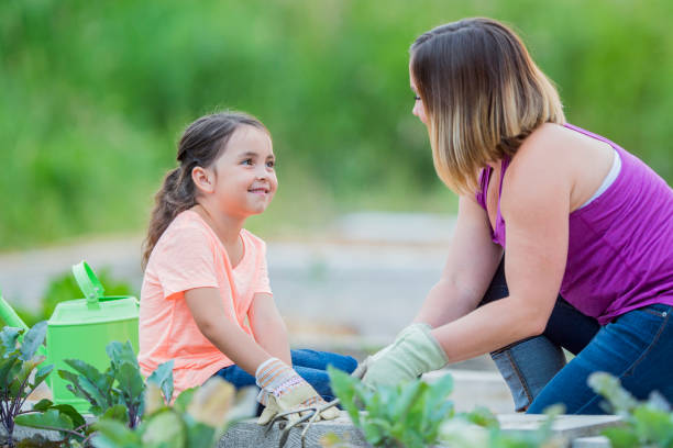 istock Mother And Daughter Talking In Garden 668161786