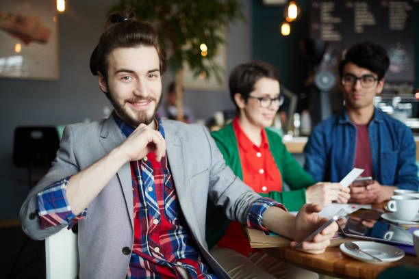 istock Young Creative Businessman Smiling in Meeting 668161974