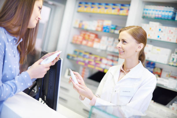 istock Female pharmacist advising with medicine 668164992
