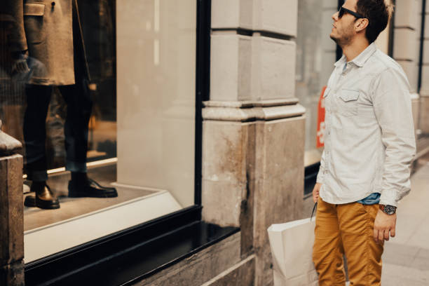 istock Good-looking man window shopping in Europe 668170990