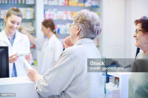 Customers Been Waiting On The Queue In Drug Store Stock Photo - Download Image Now - Pharmacy, Senior Adult, Waiting In Line