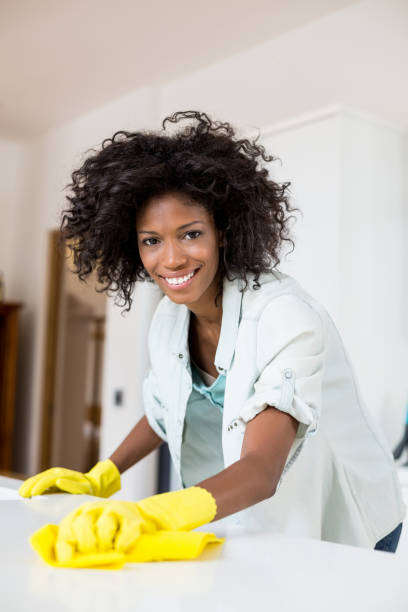 istock Woman cleaning kitchen counter 668174366