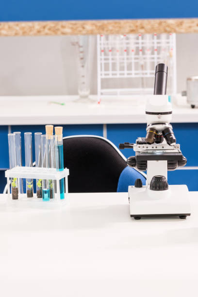istock tubes and microscope standing on table in empty chemical laboratory 668174534