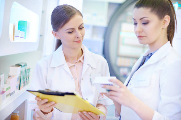 istock Pharmacists taking stock at drugstore 668175724