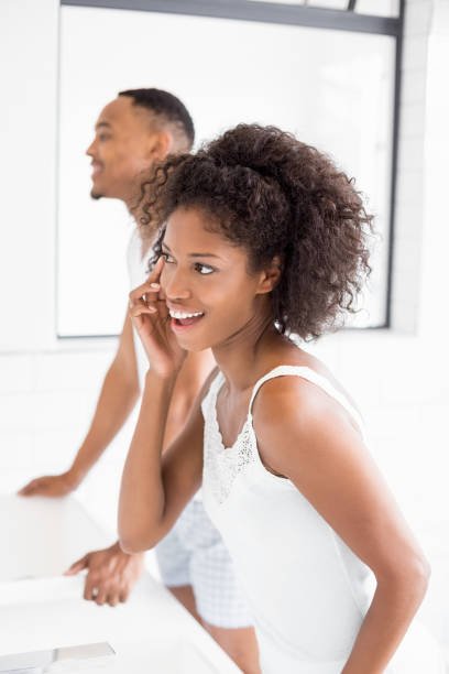 istock Woman checking her skin in bathroom 668178346