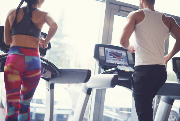 istock Fit couple exercising on treadmill 668182236
