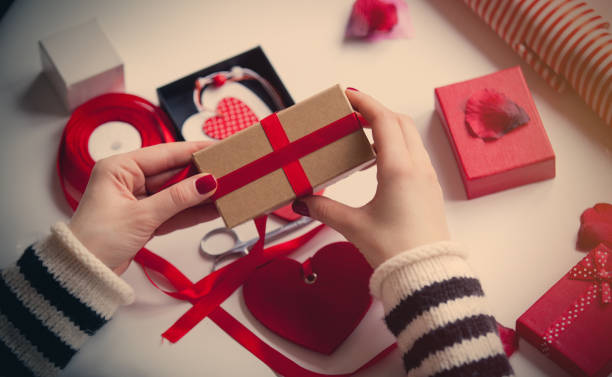 istock white caucasian hands wrapping gift on the wonderful things for decoration background 668185354