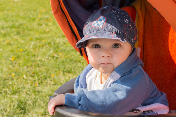 Cute baby boy in a stroller.