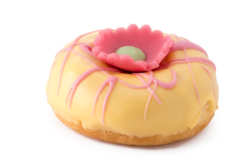 An easter donut with a marzipan flower on top.
