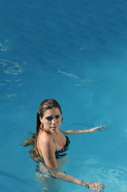 istock Beautiful blonde woman in pool 668193926
