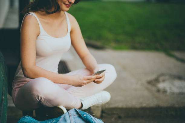 istock teenager girl using smart phone 668194106