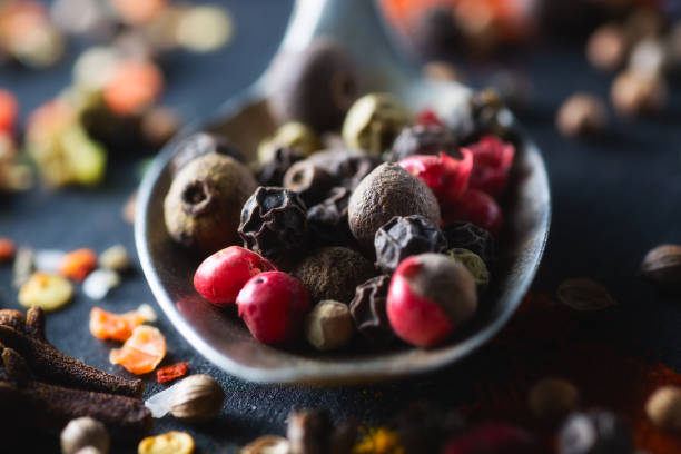 istock Spoon with mixture peppercorns closeup  chalkboard 668194386