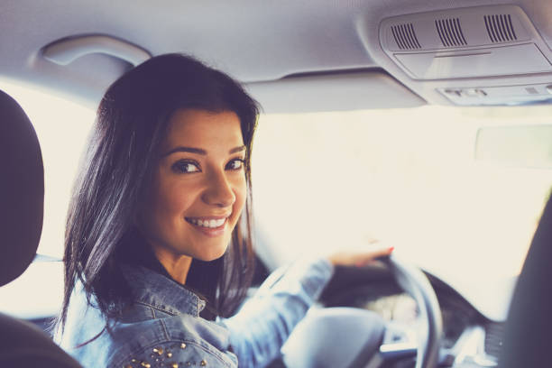 istock Smiling woman sitting in a car 668197214
