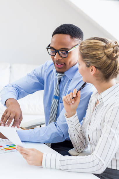 istock Business colleagues discussing a report 668198140