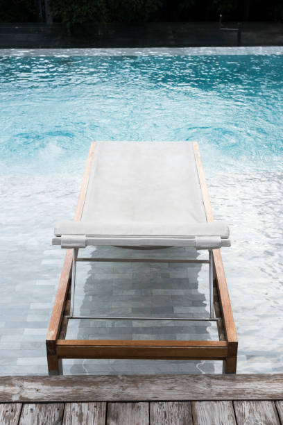 istock Chaise lounges in swimming pool 668201580