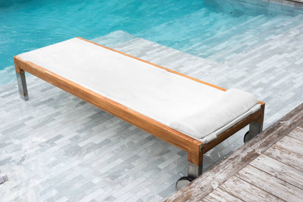 istock Chaise lounges in swimming pool 668201632