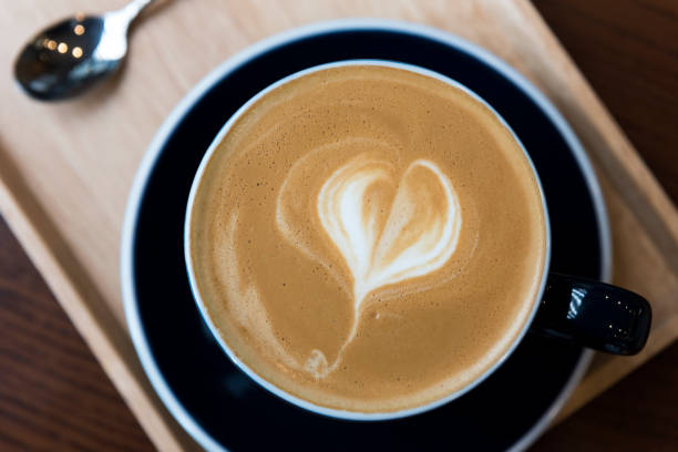 istock Cup of coffee with latte art on wooden table 668201730