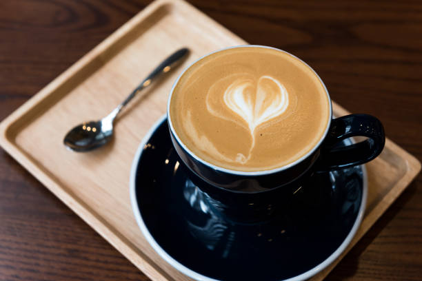 istock Cup of coffee with latte art on wooden table 668201734