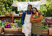 Greengrocer selling organic fresh agricultural product at farmer market