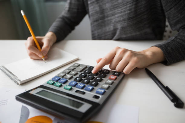 istock Closeup of Economist Working and Using Calculator 668208700