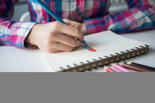 istock Closeup of Designer Drawing With Colored Pencils 668208754
