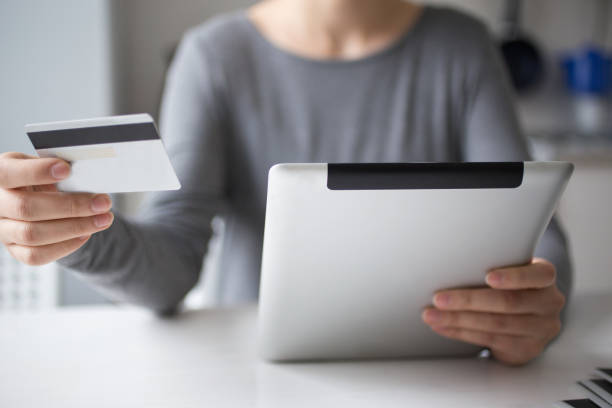 istock Person Shopping Using Credit Card and Tablet 668208828