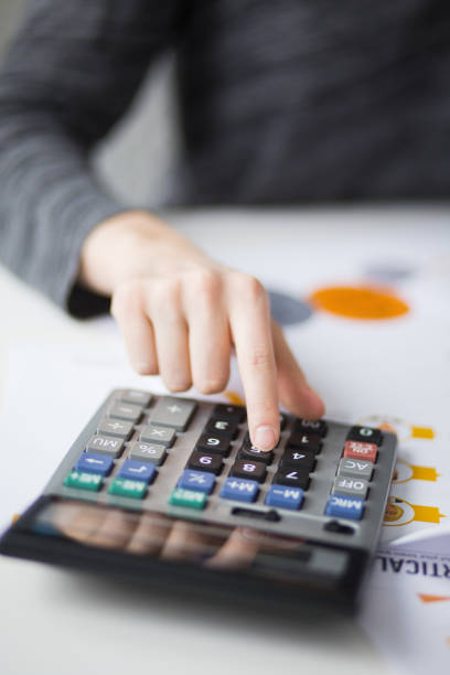 istock Closeup of Hand Pushing Button on Calculator 668208940