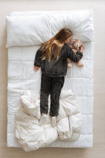 istock Sweet cute child holding her teddy bear close 668214684