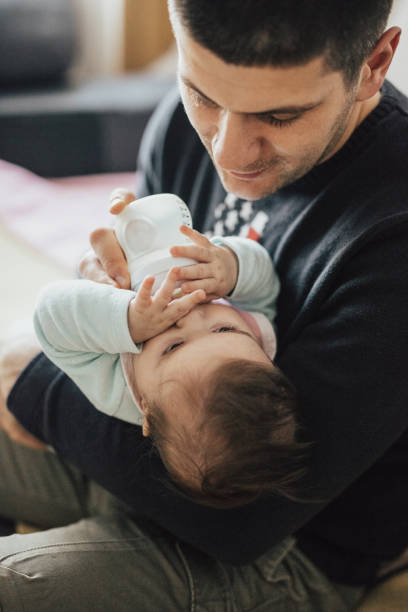 istock Father feeding newborn baby 668214742