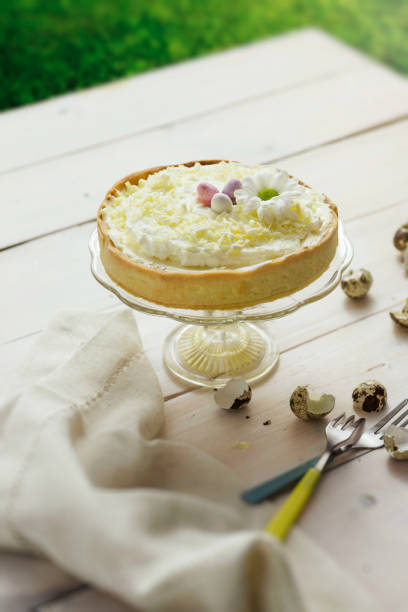 istock Lemon tart with whipped cream, decorated with chocolate eggs and a flower. 668215210