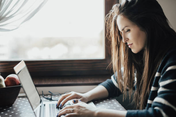 Free Stock Photo of Female developer hands on laptop with books on ...