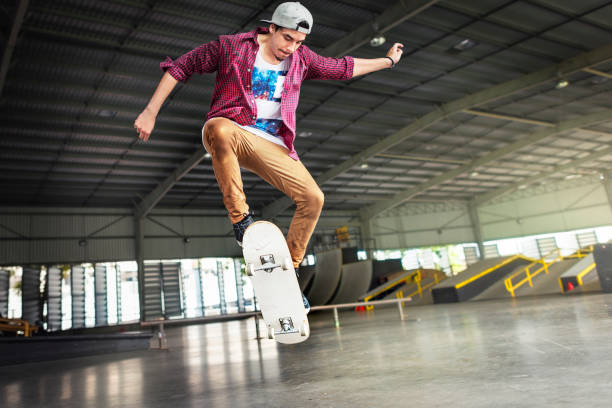 Boy Skateboarding Jump Lifestyle Hipster Concept Boy Skateboarding Jump Lifestyle Hipster Concept Ollie stock pictures, royalty-free photos & images