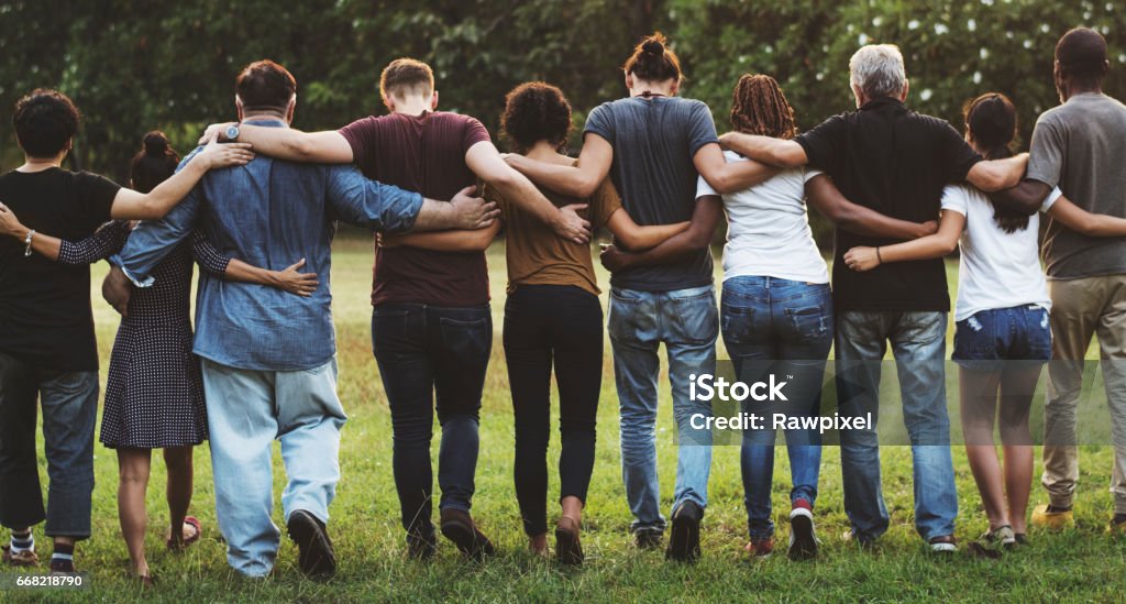 Group of friends huddle in rear view together People Stock Photo