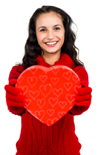 istock Smiling woman holding heart shape box 668221852