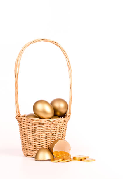 istock gold egg in basket on white background 668225038