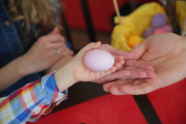 istock Happy Easter. the child holding the egg 668226400