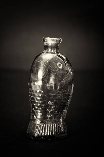 istock Old colourful bottles against a dark background 668232956