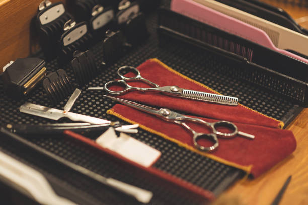 istock Professional scissors and combs lying on the table in barbershop 668233298