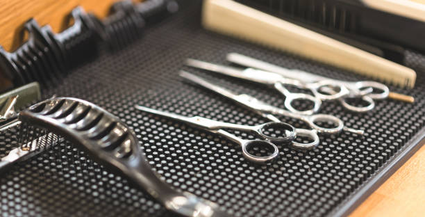 istock Metal scissors lying on the table in the barbershop 668233350