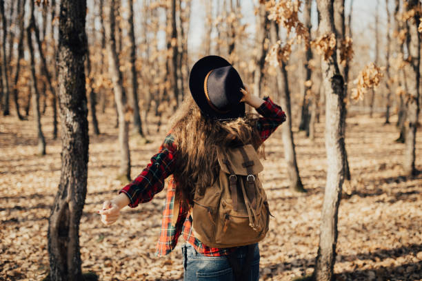 istock Wind blows and girl holds a hat 668236400