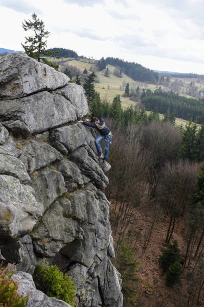 istock Young male climbing on the rock 668236876