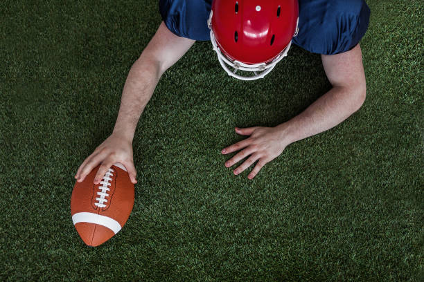 istock American football player scoring a touchdown 668239862