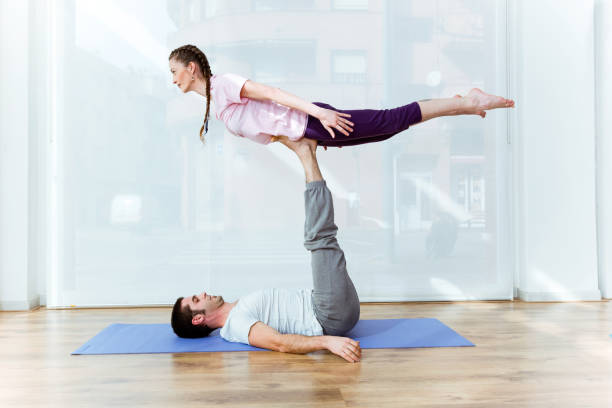 istock Beautiful young couple practicing yoga at home. 668242762