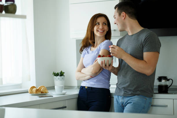 istock Attractive couple having fun eating breakfast 668253994