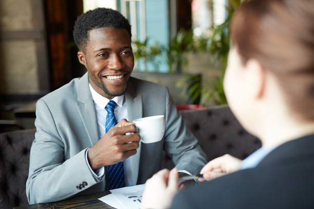 istock Smiling African Businessman in Meeting 668256434