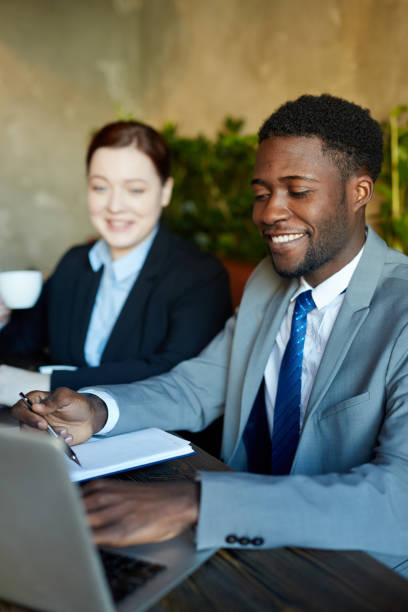 istock Successful African Businessman at Meeting in Modern Office 668256490
